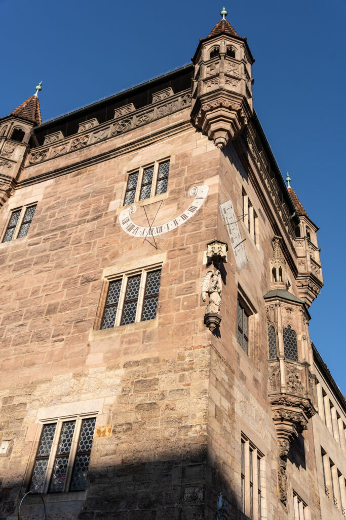 Sundial Clock Outside Walls in Nuremberg, Photo by Alex Lau