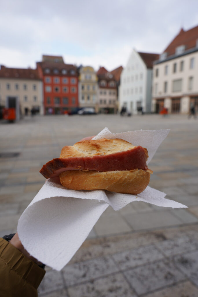 Eating Leberkäse by Neupfarrplatz, photo by Alex Lau