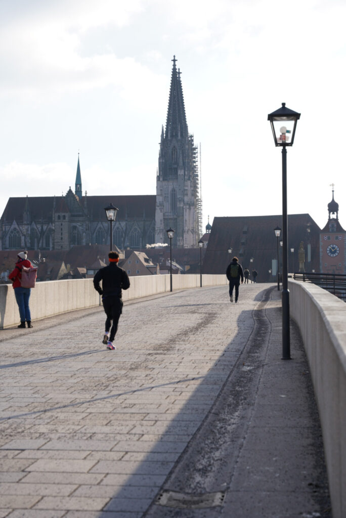 A runner one the stone bridge at Regensburg, Germany, photo by Alex Lau