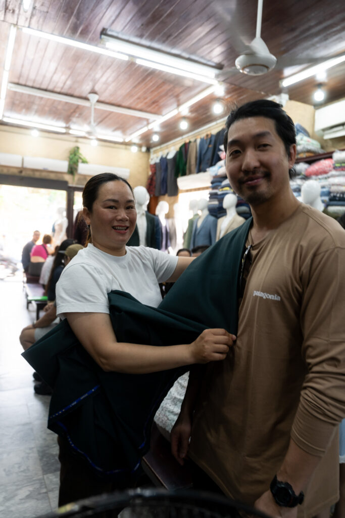Choosing fabric at Ba Ri Tailor in Hoi An, photo by Alex Lau