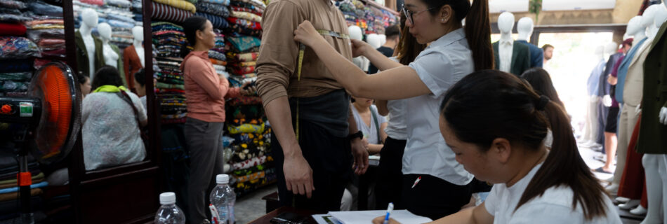 Getting measured at Ba Ri Tailor in Hoi An, photo by Alex Lau