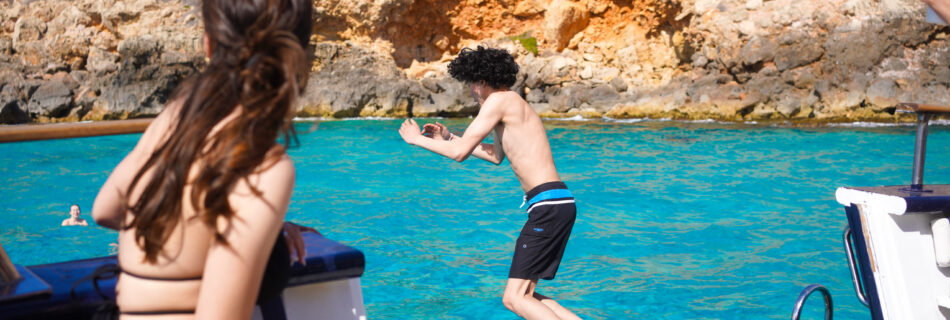 Diving into the water during Palma Bay Boat Tour and Snorkel in Spain by Sa Calma Boats, photo by Alex Lau