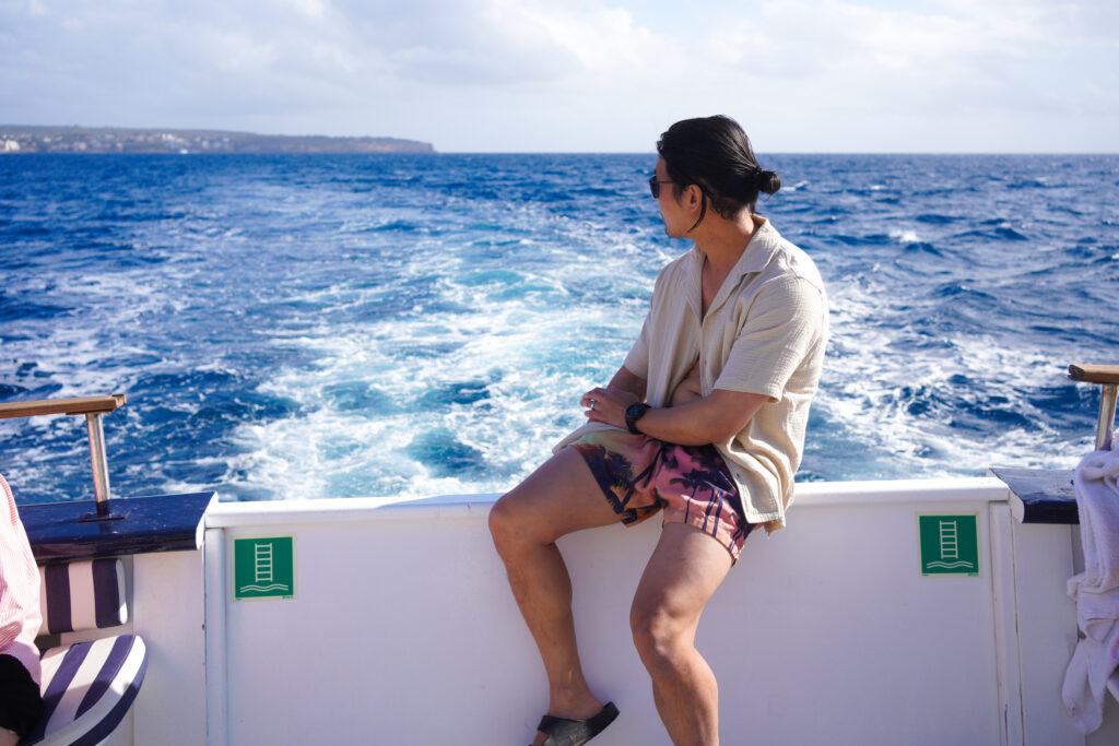 Alex sitting on boat during Palma Bay Boat Tour and Snorkel in Spain by Sa Calma Boats, photo by Alex Lau